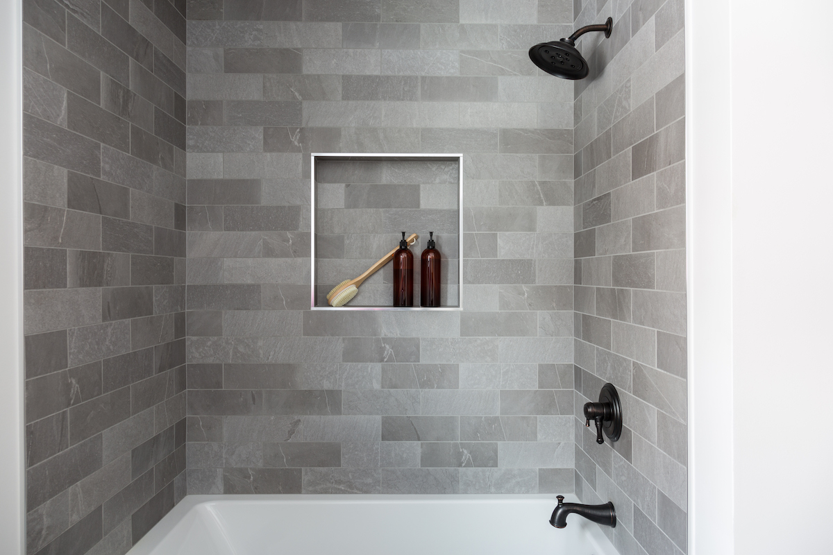 gray-tile-shower-bathtub-black-fixtures